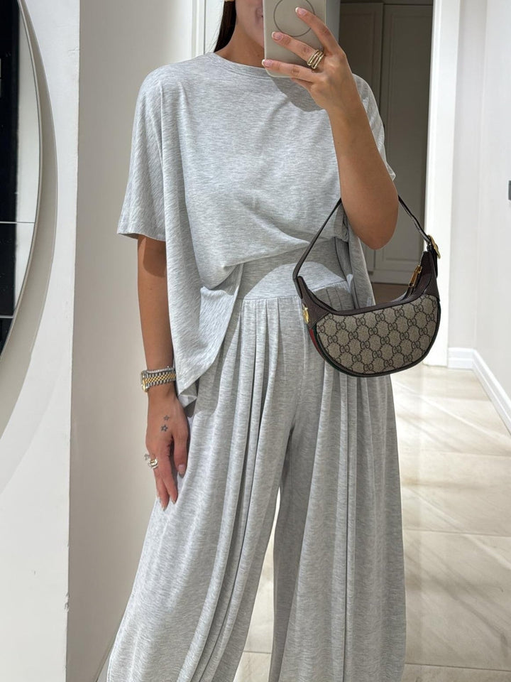 Front view of the wide-leg pants set in light grey showing the soft drape and relaxed fit