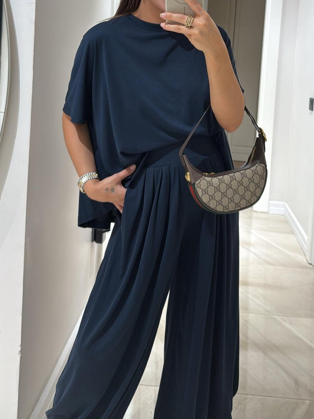 Close-up detail of the casual top and wide-leg pants set in navy highlighting fabric texture