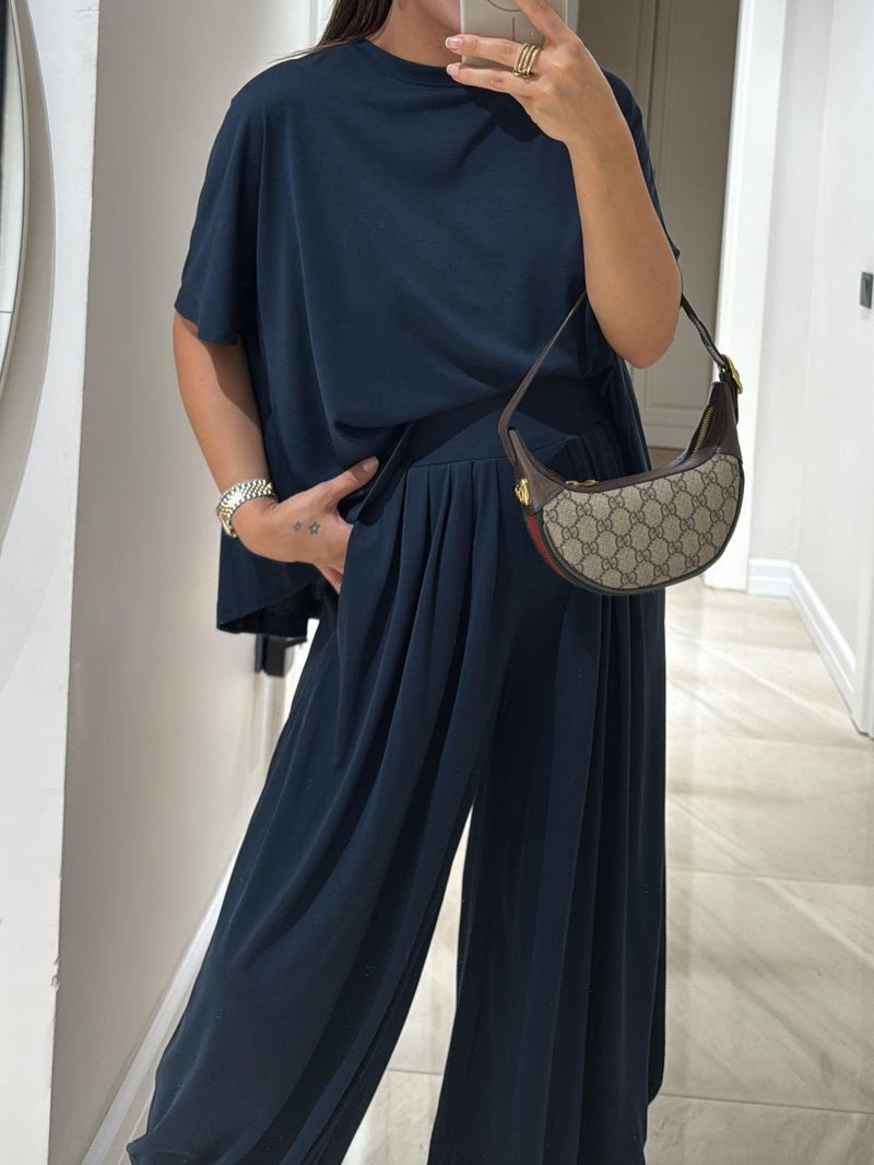 Close-up detail of the casual top and wide-leg pants set in navy highlighting fabric texture