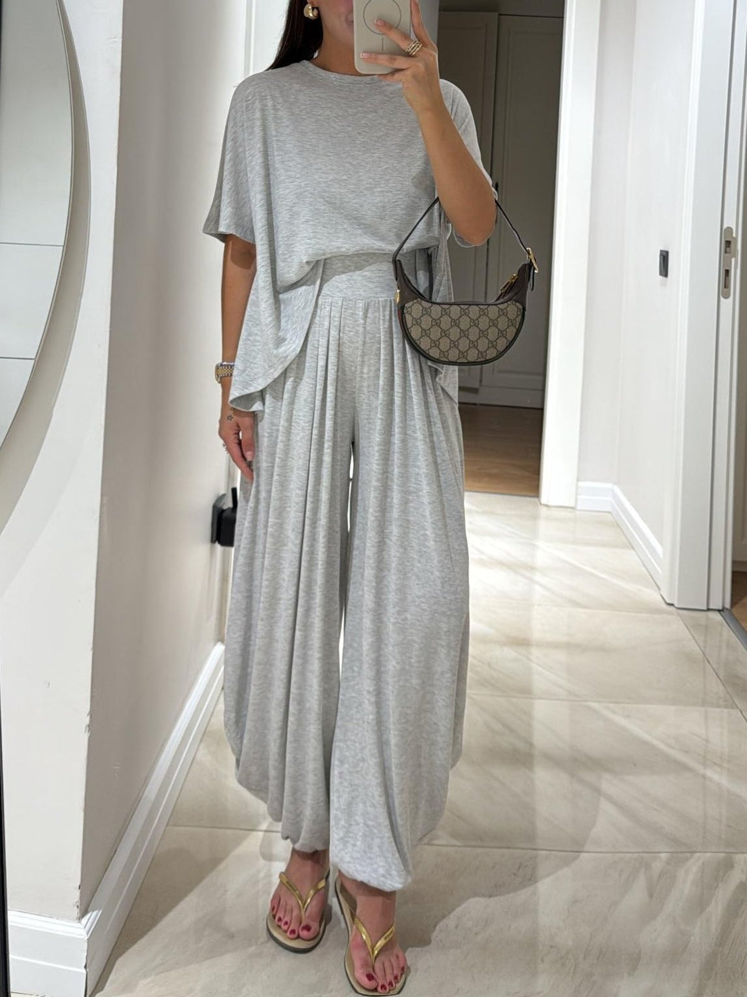 Full-length side view of model in brown two-piece wide-leg pants set