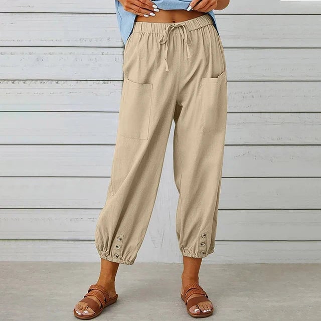 Side view of women's relaxed straight pants highlighting deep front pockets and flowing fabric drape