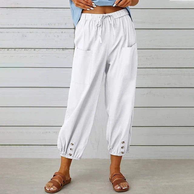 Florimay Lena pants in a dark color option, worn by a female model in a casual everyday outfit