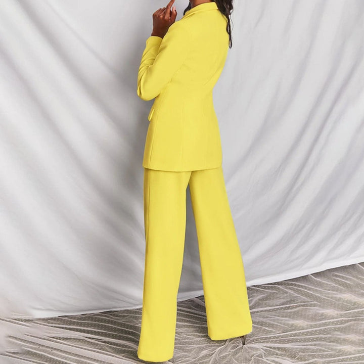 Side profile of model in the Florimay structured blazer and high-waisted trousers set