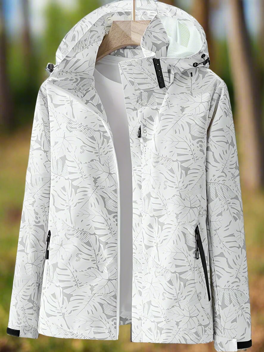 Side view of a woman in a pink waterproof summer jacket showing the adjustable hood and tailored fit
