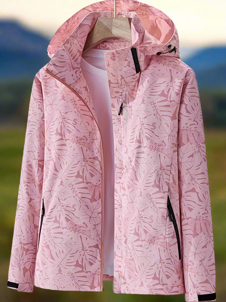 Woman in a white leaf-print waterproof jacket outdoors on a rainy summer day