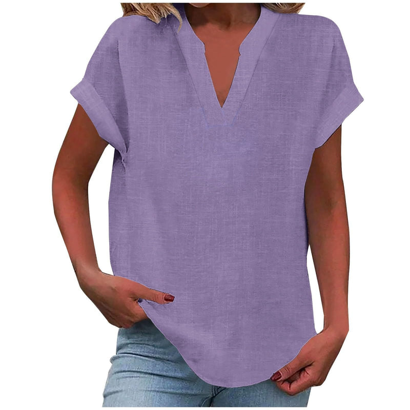Model wearing a light purple relaxed V-neck blouse with rolled short sleeves and a notched neckline
