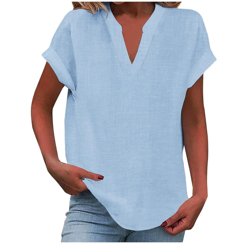 Close-up of the notched V-neckline and rolled sleeve detail on the Lexi blouse
