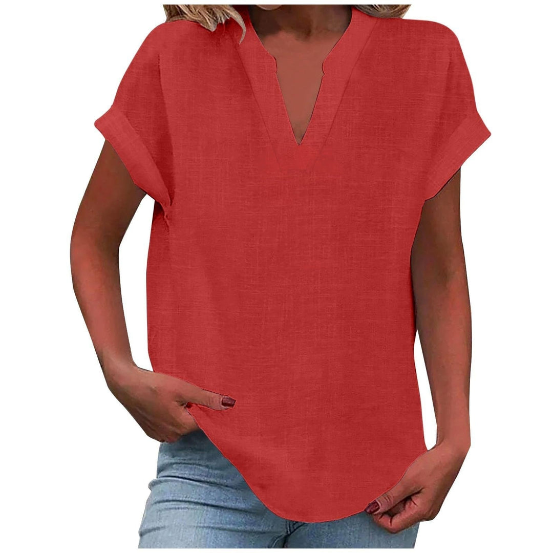 Model styling the relaxed V-neck blouse with high-waisted trousers for a polished everyday look