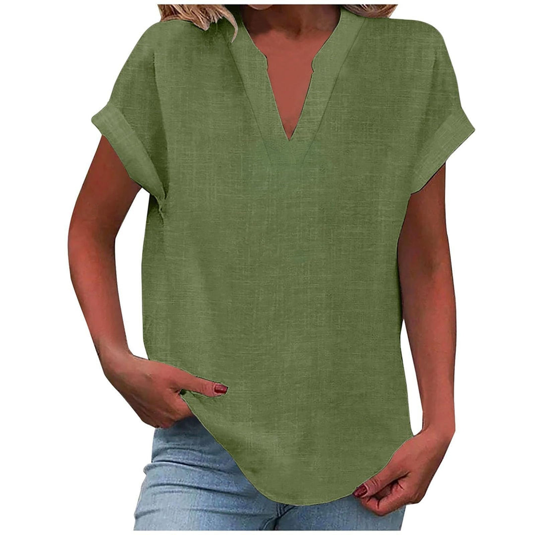 Lifestyle shot of model in the Lexi relaxed V-neck blouse in beige against a neutral background