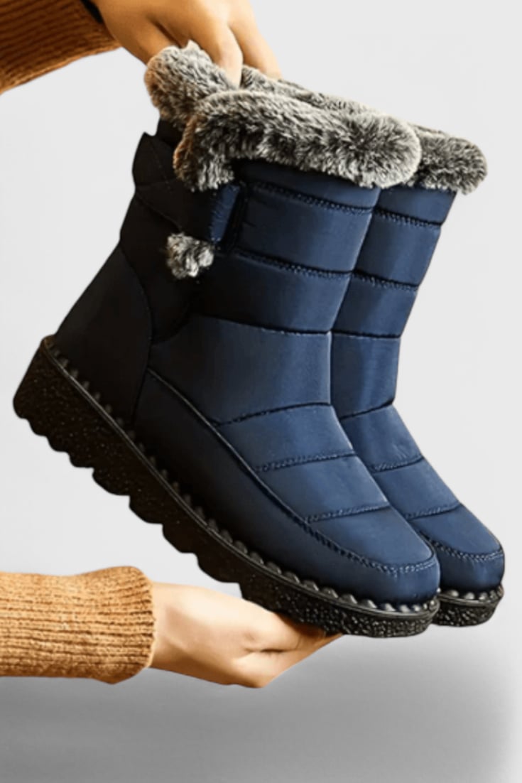Front view of women's waterproof mid-calf boots with slip-resistant sole in a sleek polished silhouette