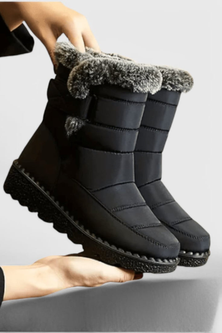 Detail shot of women's waterproof boots highlighting the durable sole and streamlined mid-calf design