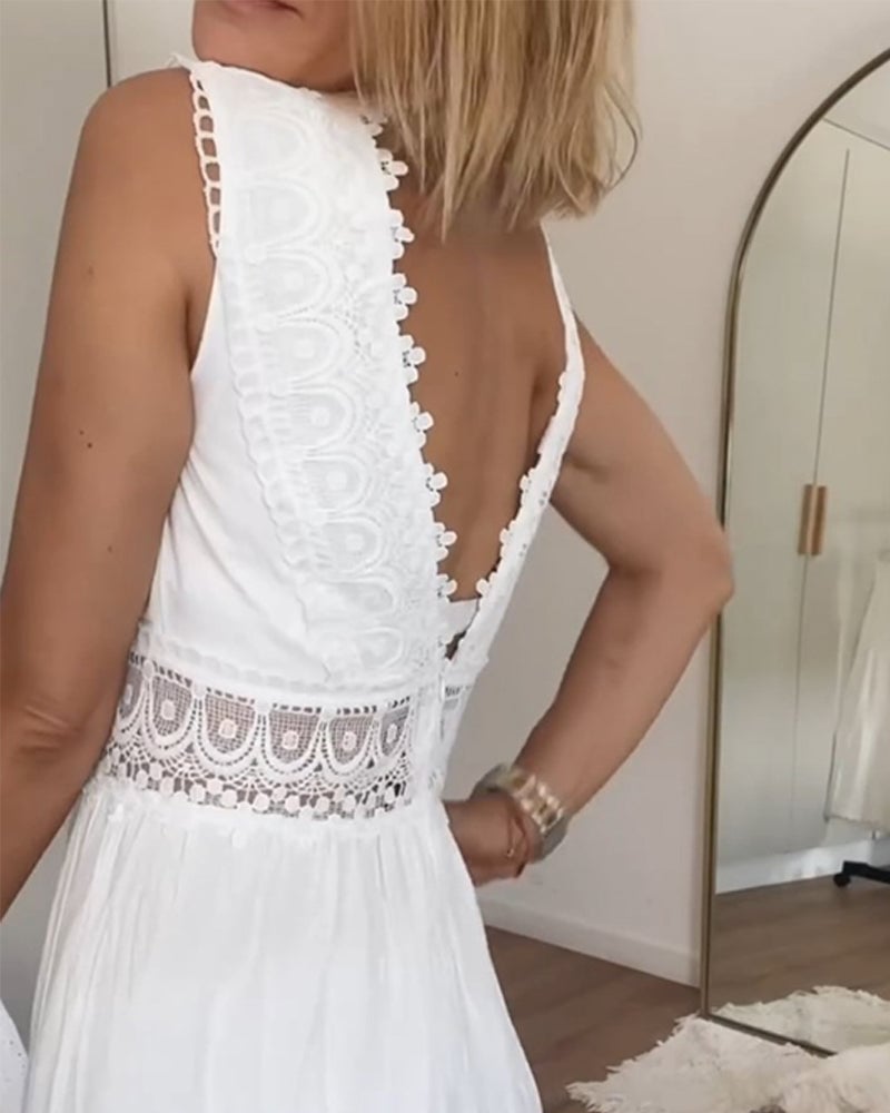 Close-up of the tie-waist detail on a white boho wrap dress with flowing fabric