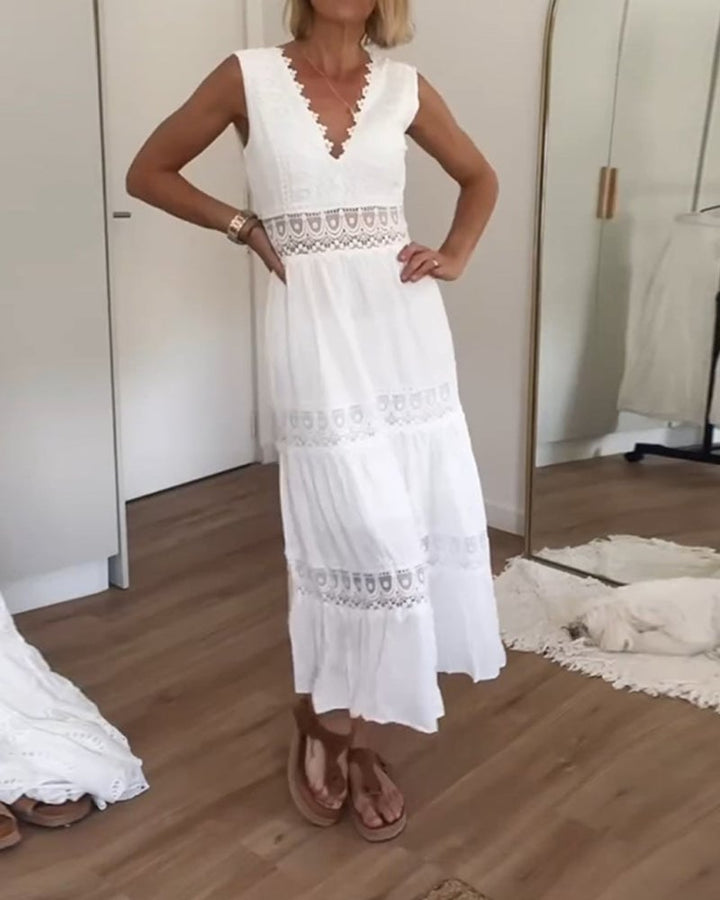 Full-length lifestyle shot of a woman in a white flowy boho wrap dress in a bright outdoor setting