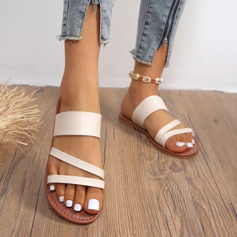 Lilac flat sandals in beige showing cushioned footbed detail from above
