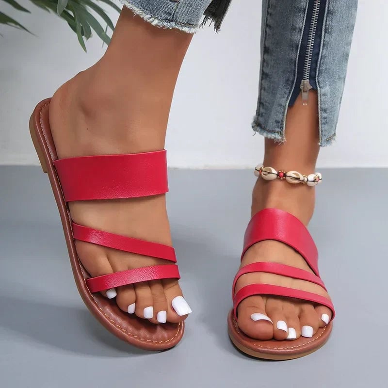 Close-up of Lilac flat sandal sole and flexible outsole in brown colorway