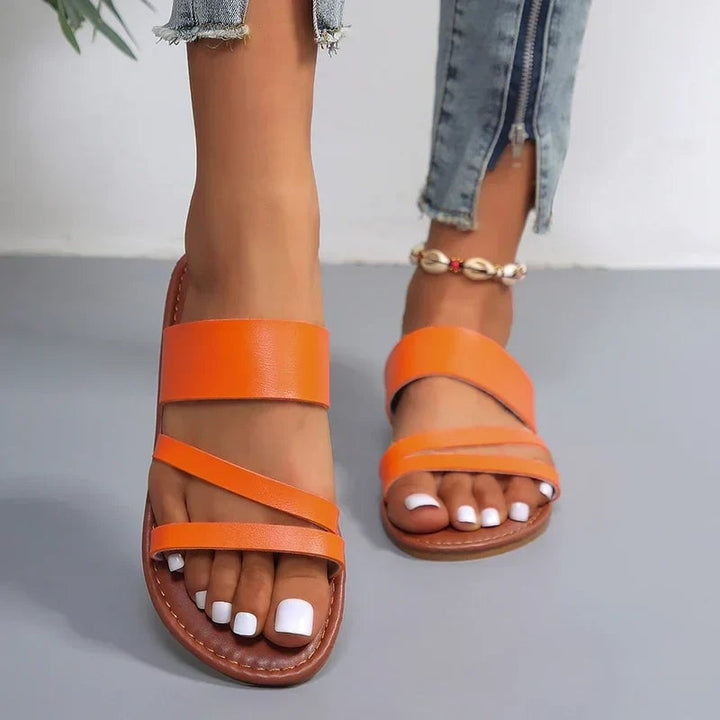 Lilac sandals in orange colorway, three-quarter view showing strap and toe design