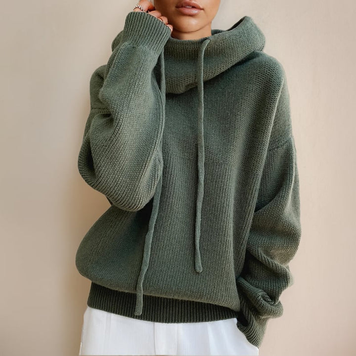 Woman wearing the Luna cozy hoodie sweater in green, relaxed fit with a sleek silhouette