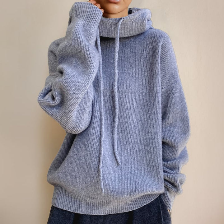 Woman layering the Luna hoodie under a coat for a chic winter look