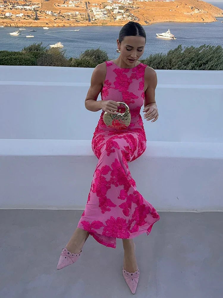 Side view of an elegant pink floral maxi dress highlighting the drape and fit over the hips
