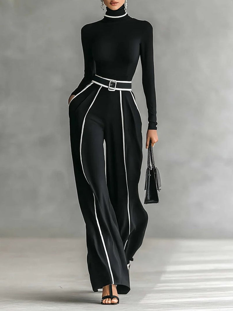 Woman wearing a gray high-neck long-sleeve top and matching wide-leg pants set with a coordinating belt