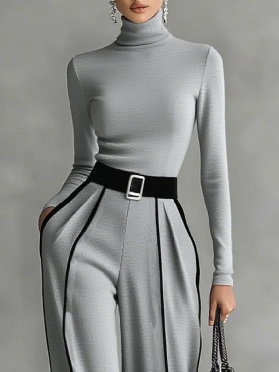 Full-length front view of black high-neck top and wide-leg pants set styled with belt