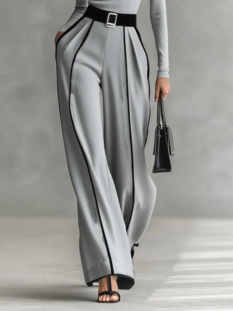 Detail shot of matching belt cinching the waist of the black wide-leg pants set