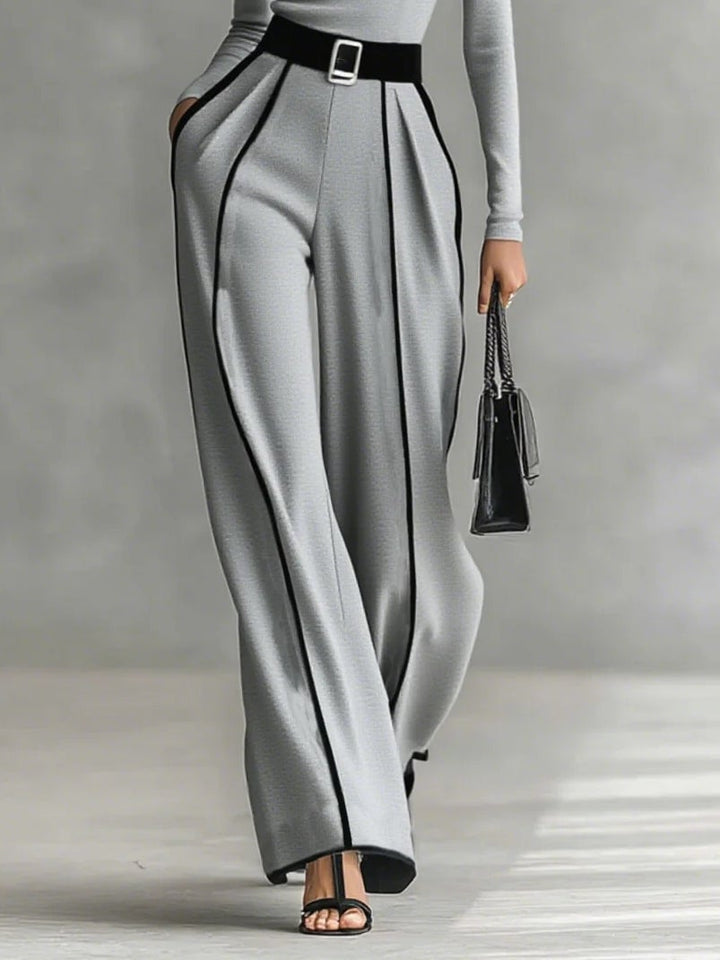 Detail shot of matching belt cinching the waist of the black wide-leg pants set