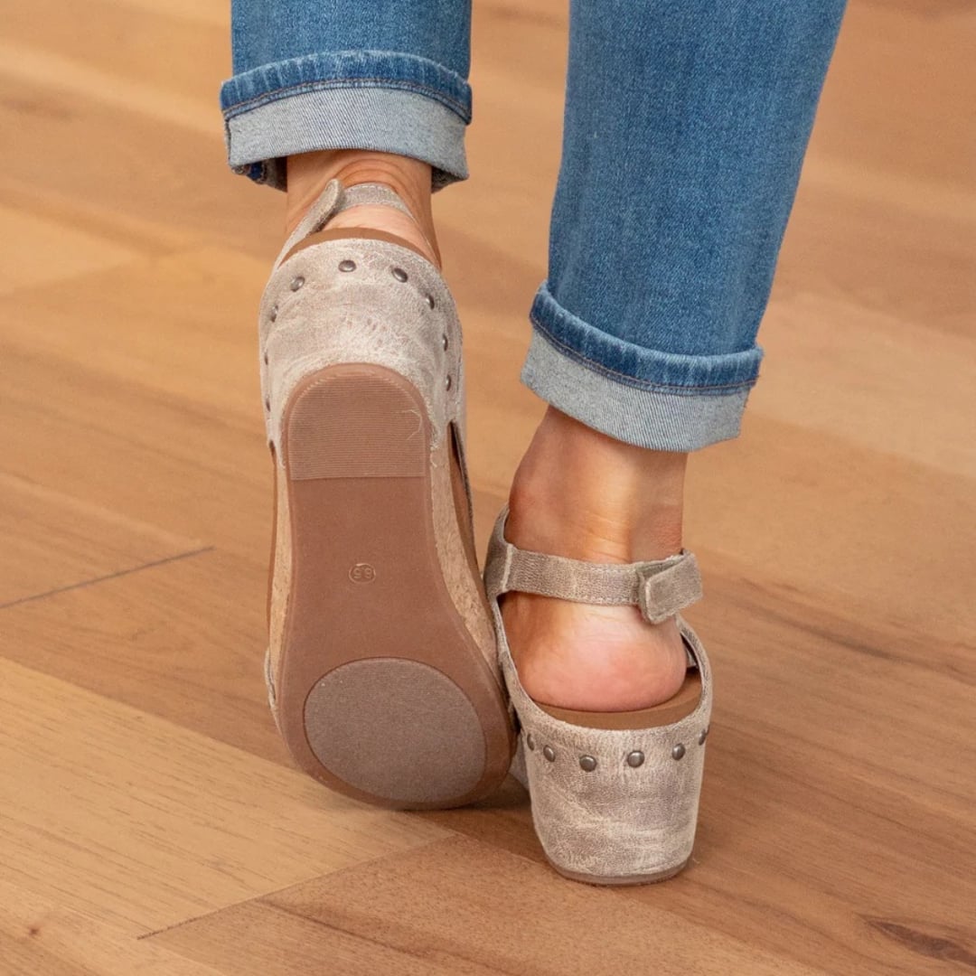 Close-up of elastic strap detail on Linda suede wedge sandals in brown