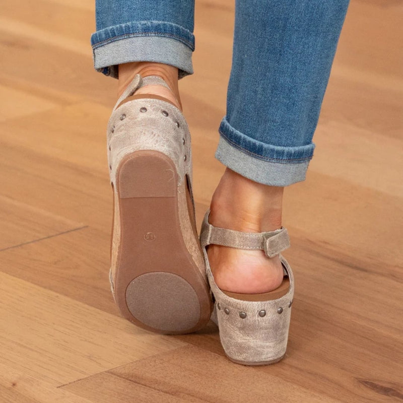 Close-up of elastic strap detail on Linda suede wedge sandals in brown