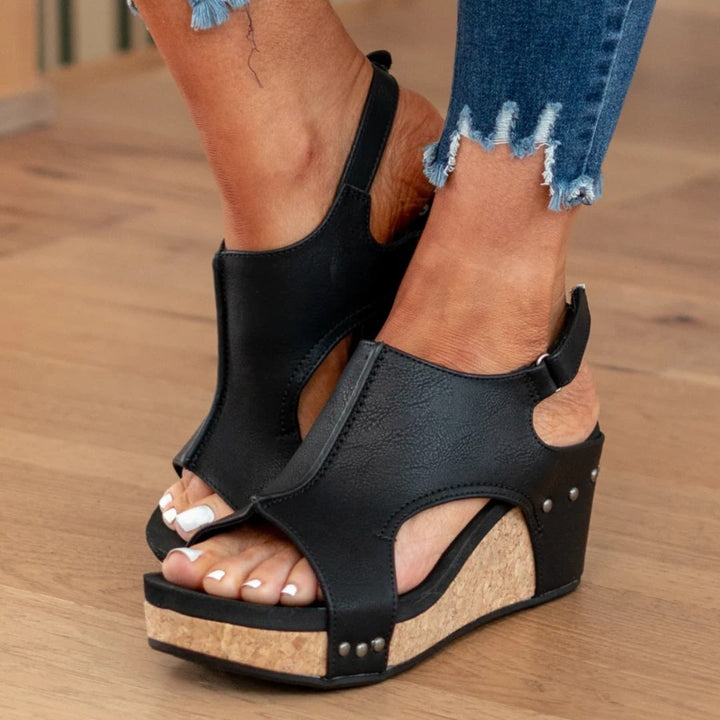 Linda brown suede wedge sandals on a neutral background, top-down view