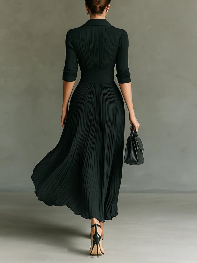 Black elegant maxi dress with tailored lapel collar and pleated skirt, side profile view