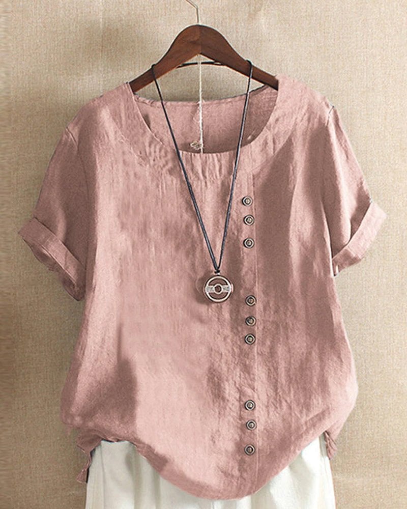 Front view of women's linen button-front crew neck short sleeve top in pink with tonal button placket and curved hem