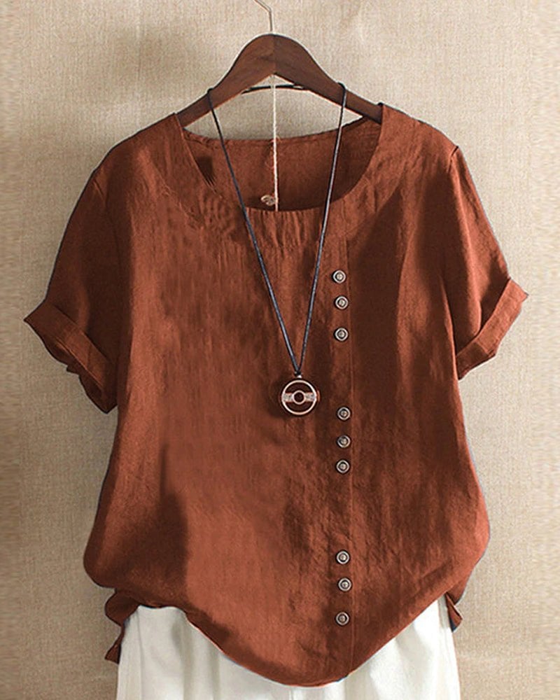 Women's linen button-front top in white styled with casual trousers, showing full front detail