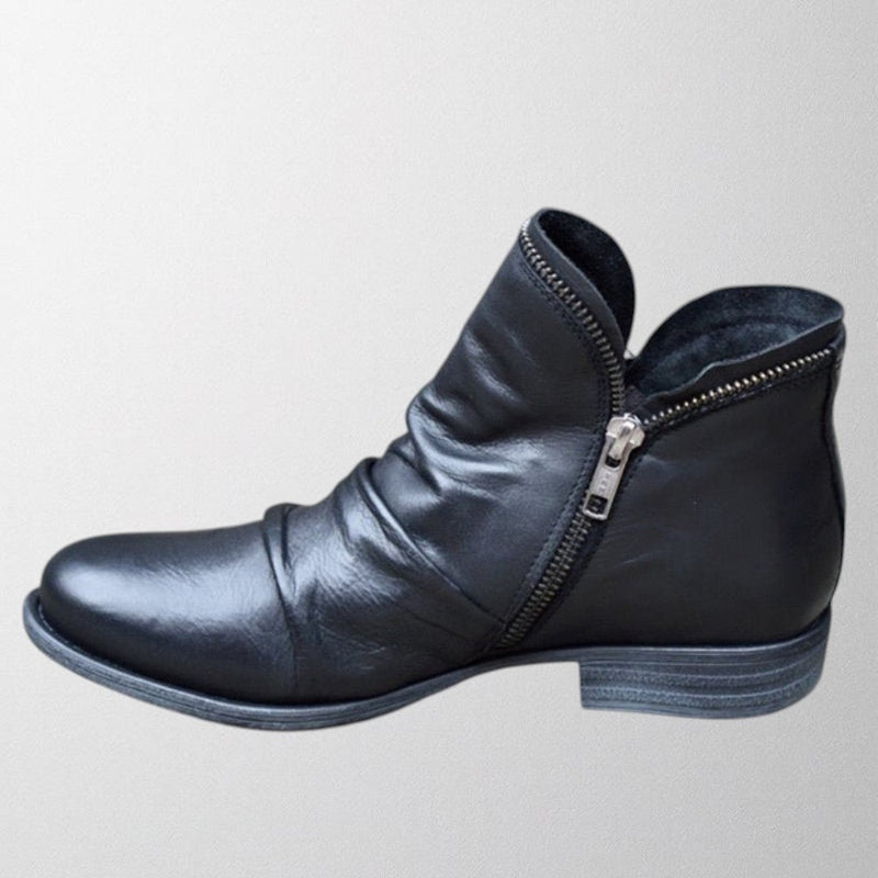 Side profile of Lisa orthopedic boots in black highlighting contoured arch support and streamlined design