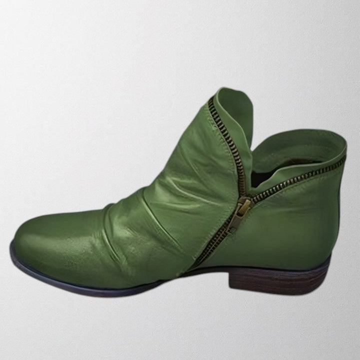 Pair of Lisa orthopedic boots in green laid flat showing cushioned insole and soft upper material