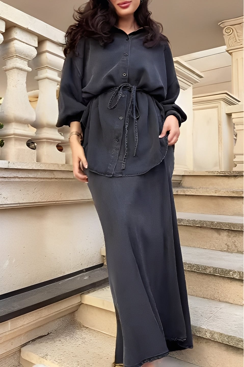 Model wearing a coordinated long-sleeve tie-drawstring shirt and skirt set in a relaxed fit