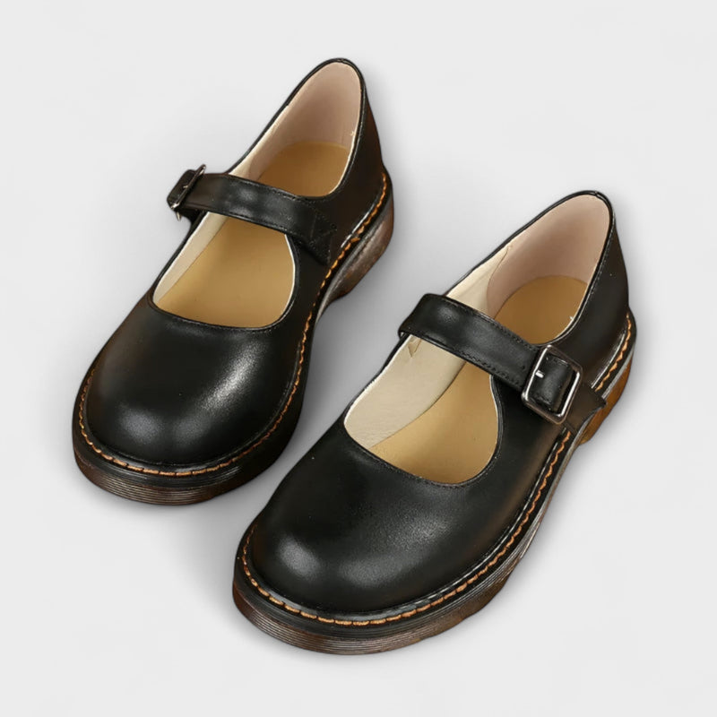 Women's black vintage Mary Jane sandal with adjustable strap and non-slip comfort sole, side profile view