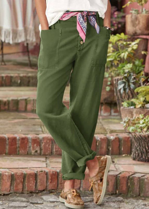 Gray high-waist relaxed trousers with soft pleat detail on a model
