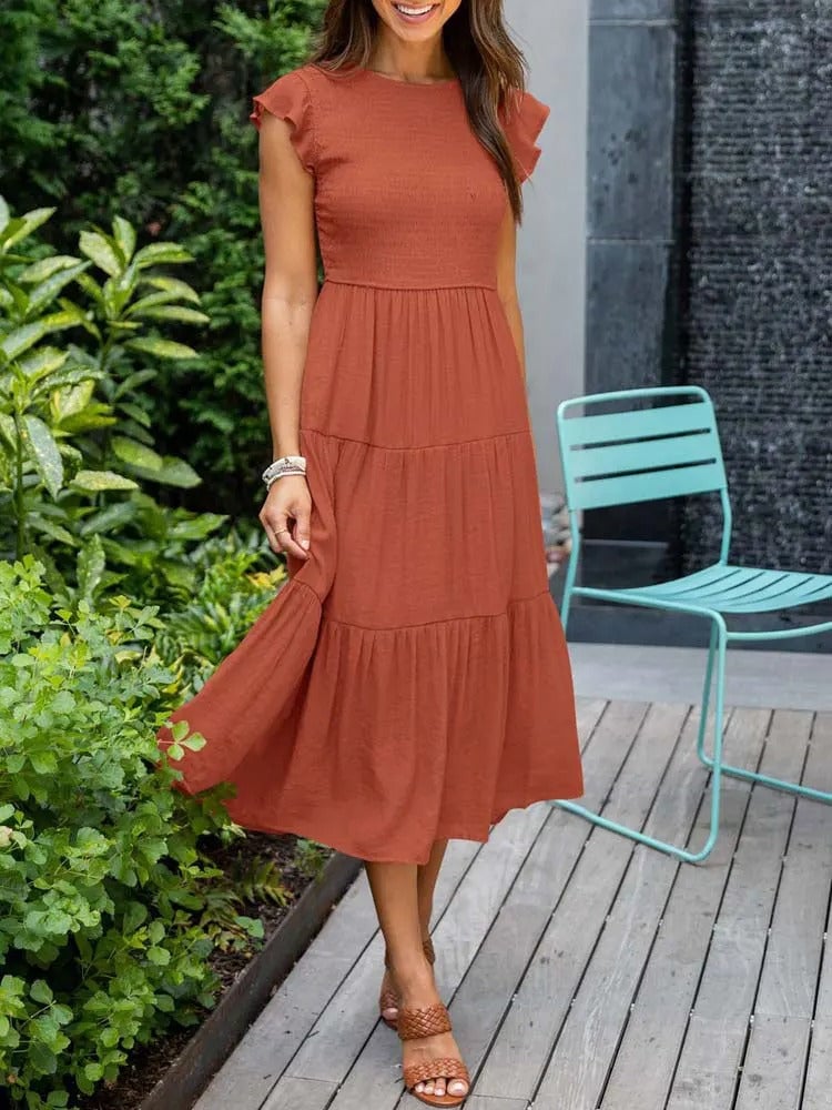 Front view of the Lisette tummy control draped dress in orange showing the flattering gathered midsection