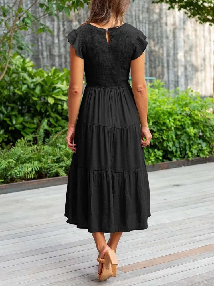Back view of the Lisette draped dress in orange displaying the clean elegant finish
