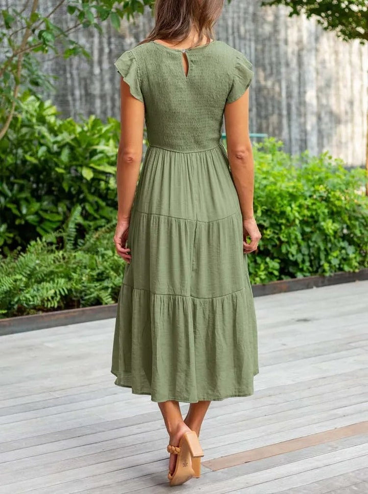 Front view of the Lisette draped dress in white with flattering gathered front panel