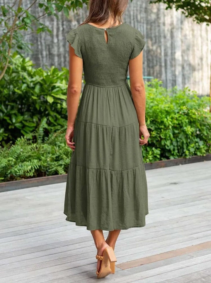 Full-length front view of the Lisette elegant draped dress in black