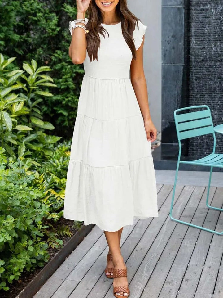 Side view of the Lisette dress in dark green highlighting the flattering fit