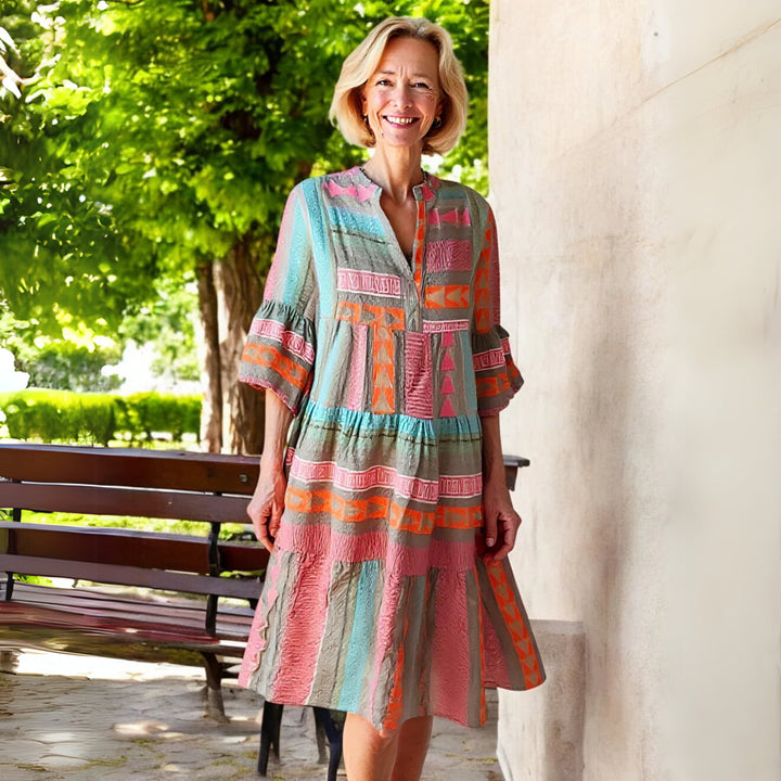 Lifestyle shot of the Lissie spring dress worn outdoors, showcasing its light and airy warm-weather style