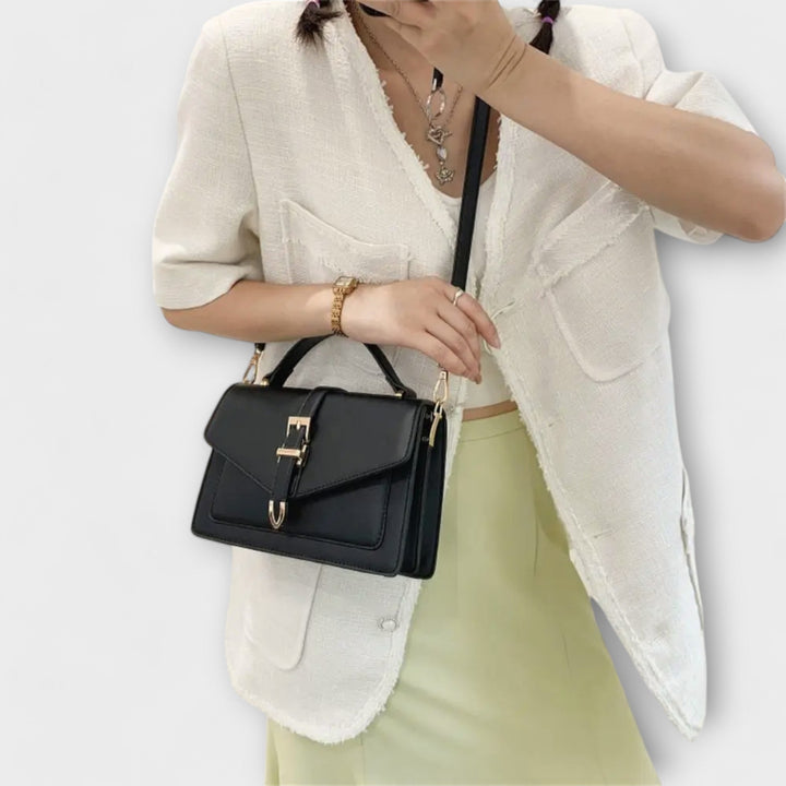 Close-up of buckle hardware and strap detail on the Liv Classic Shoulder Bag