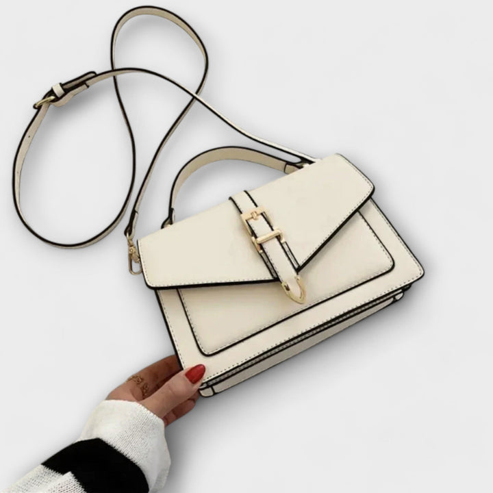Overhead flat lay of the Liv Classic Shoulder Bag in three color options: black, khaki, and white
