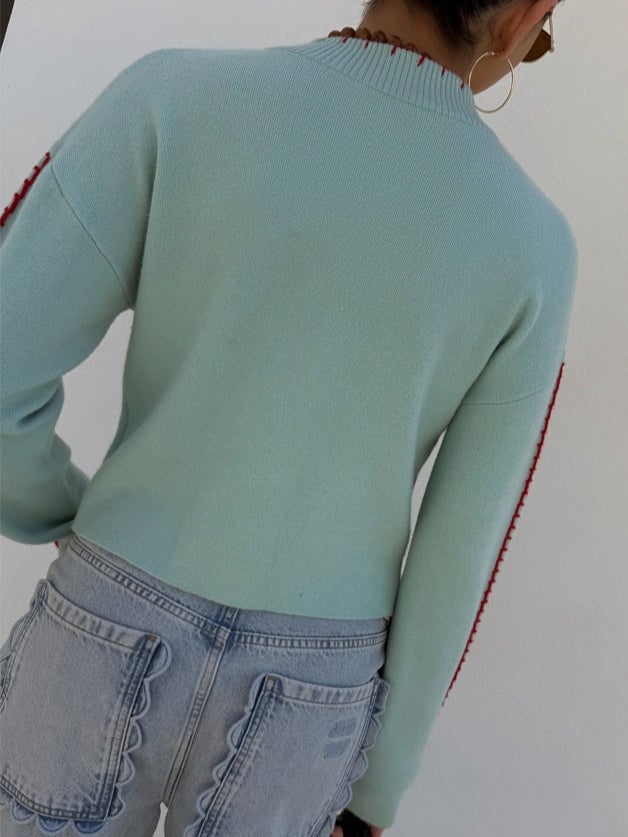 Side view of the mint green octopus print cardigan highlighting the dropped shoulder and relaxed fit