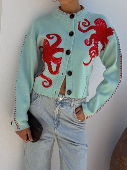 Model wearing the mint green octopus cardigan layered over a casual outfit