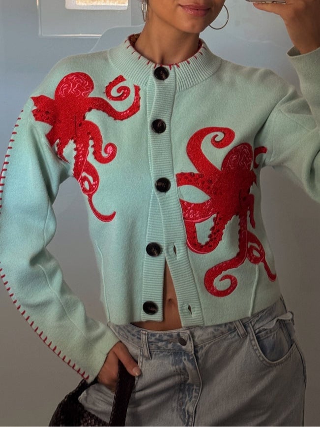 Back view of the mint green octopus pattern cardigan showing overall length and relaxed silhouette