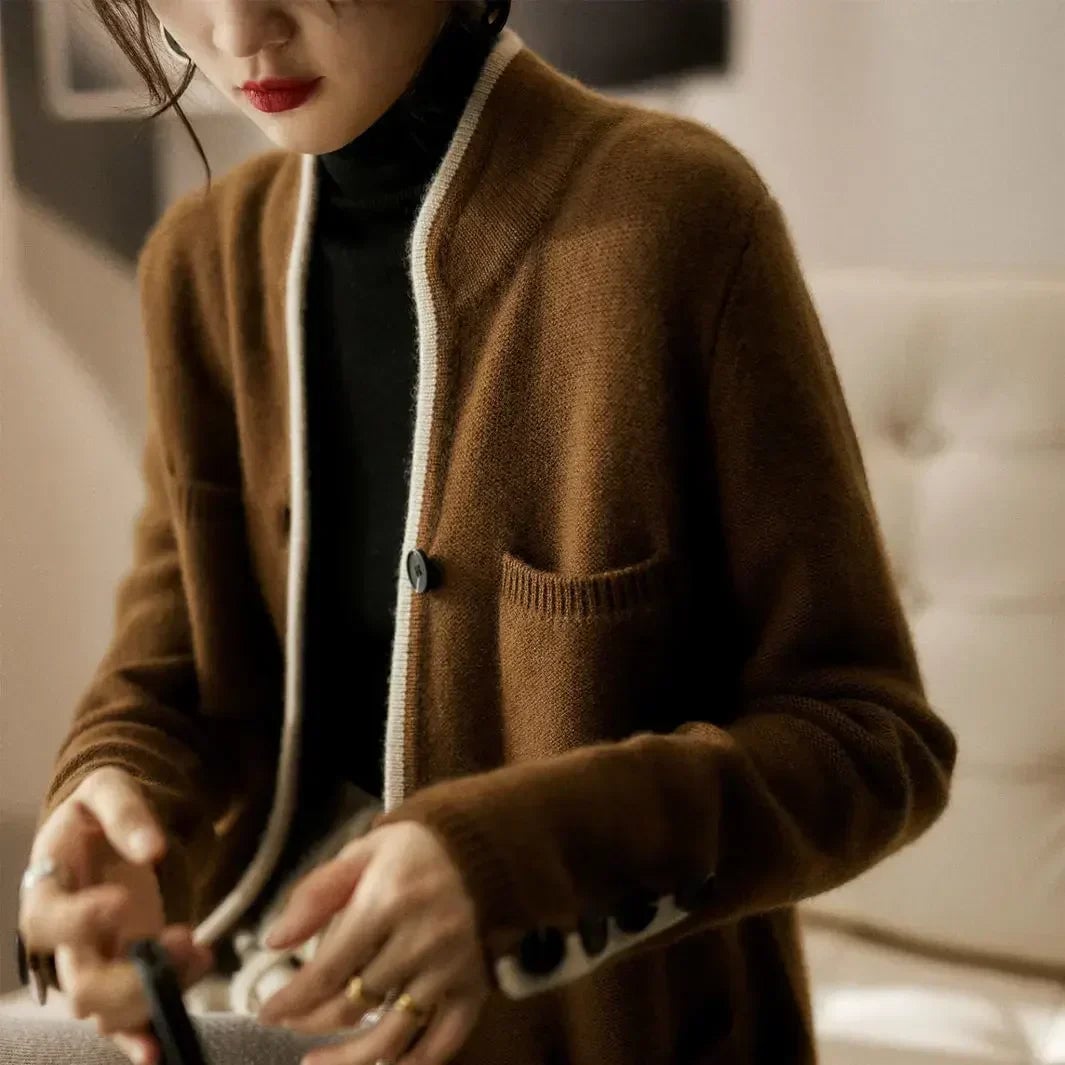Side profile of model wearing the Londyn vintage cardigan in beige layered over a simple outfit